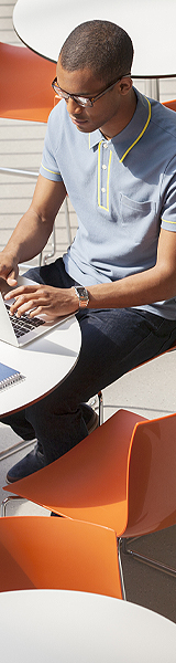 man on laptop in outdoor cafe